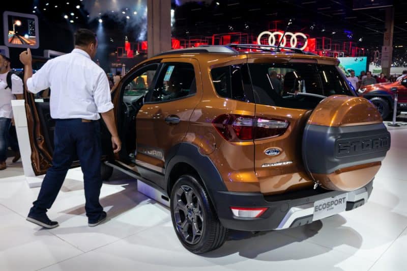 The Ford Ecosport, Equipped With A Spare Tire, Is Displayed At An Auto Show.