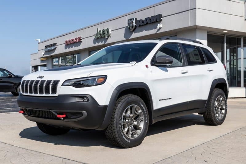 A White 2019 Jeep Cherokee Parked In Front Of A Dealership With A Bad Transmission.