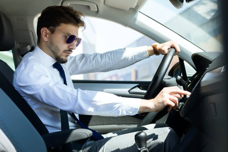 Man Using Navigator In Car